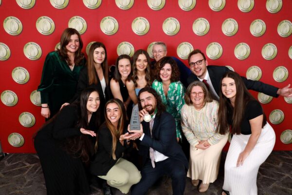 The Real Therapy Solutions team gathered around their Local Business Awards trophy on the red carpet
