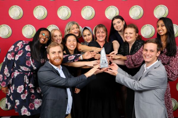 The Real Therapy Solutions team holding their Local Business Awards trophy at the awards night