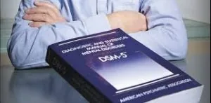 A copy of the DSM-5 diagnostic manual resting on a desk