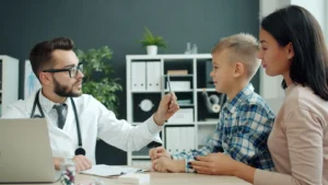 Doctor discussing health with a mother and her child in a clinic setting