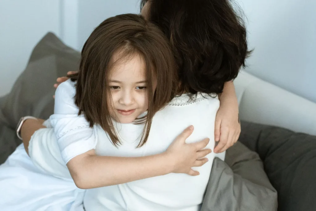 A touching moment of love and affection between a mother and her daughter sharing a warm hug