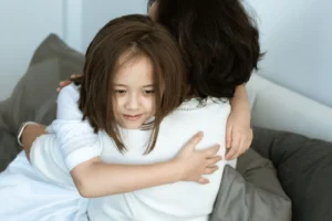 A touching moment of love and affection between a mother and her daughter sharing a warm hug