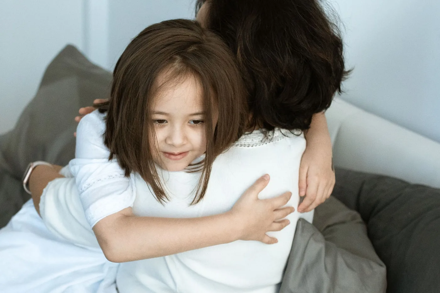 A touching moment of love and affection between a mother and her daughter sharing a warm hug