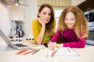 Mother daughter helping daughter with her homework