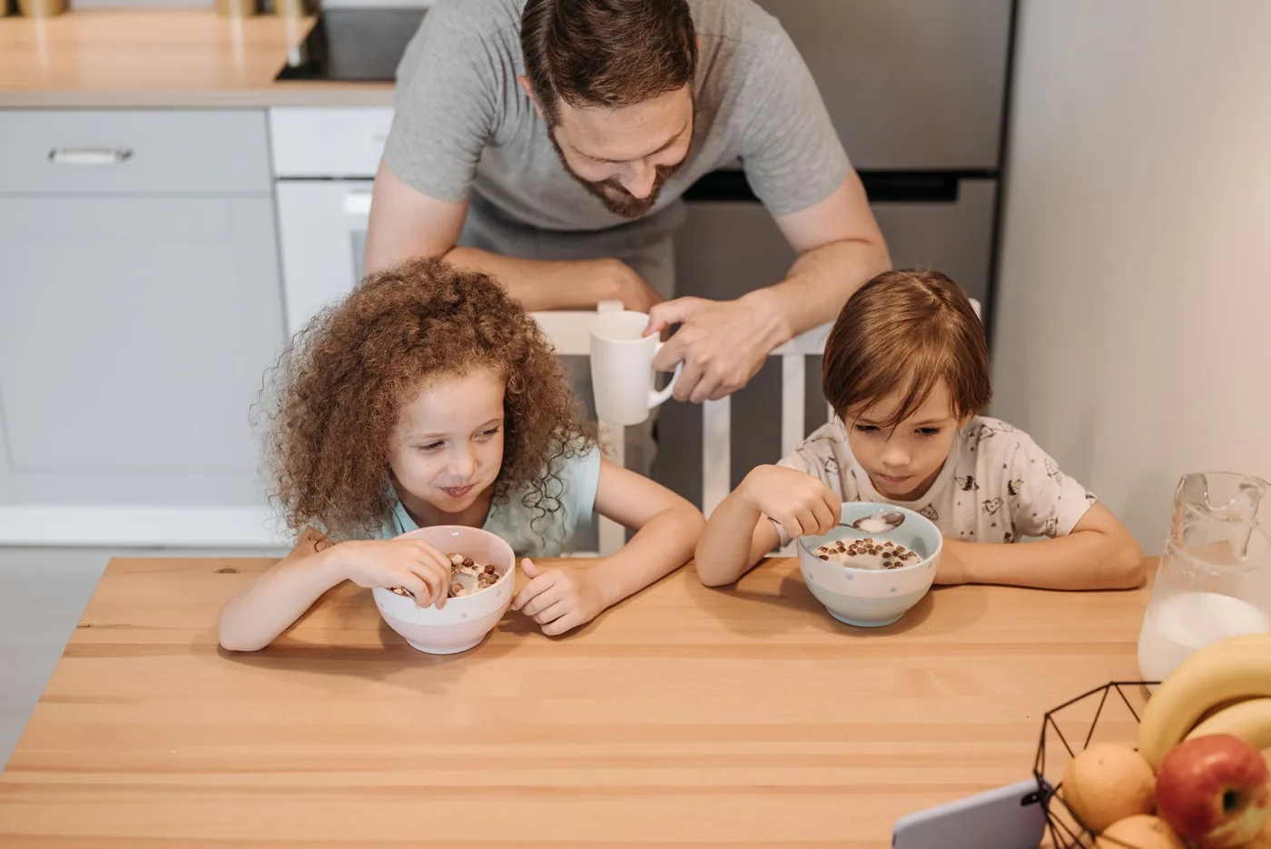 Father and children enjoying a hearty breakfast at home, creating a warm family moment