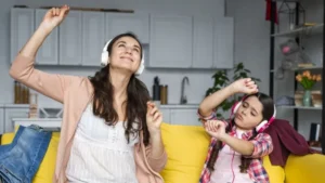 Mother daughter dancing listening music