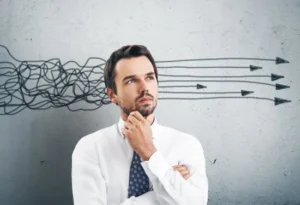 A man deep in thought beside tangled lines that straighten into arrows