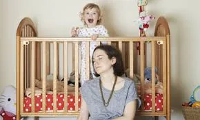 Mother asleep cot