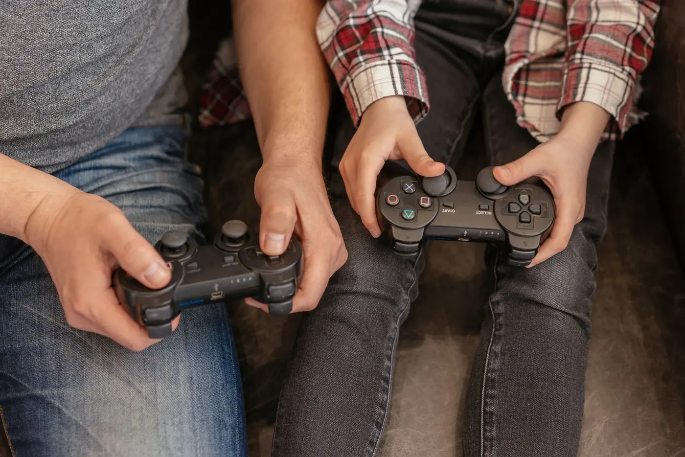 A parent and child bond over video games, sharing a fun and interactive moment with controllers