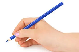 A child's hand holding a blue pencil