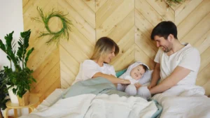Family enjoying a cozy morning in a bedroom, capturing love and togetherness